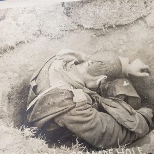 photo-of0dead-french-soldier-in-foxhole-with-head-wound-in-detail-clips-of-ammo-surrond-him-world-war-one