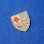 red-cross-nurse-home-care-world-war-two-pin-back-cloth-on-plastic