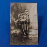 world-war-one-german-real-picture-post-card-soldier-in-field-with-backdrop-rppc