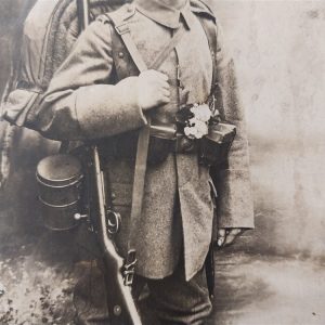 world-war-one-german-real-picture-post-card-soldier-in-field-with-backdrop-rppc