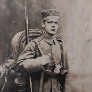 world-war-one-german-real-picture-post-card-soldier-in-field-with-backdrop-rppc