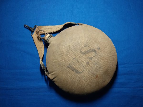 1904-dated-canteen-and-strap-produced-by-rock-island-arsenal-for-the-cavalry-set-up-on-saddle-canvas-with-y-harness-hanger