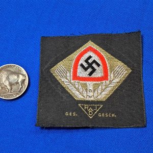 german-world-war-two-labor-cap-insignia-unissued-with-wheat-stalks-and-shovel-bevo-flat-wire-construction