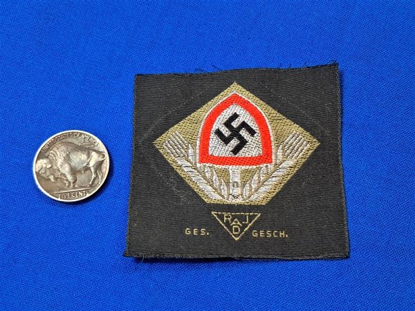 german-world-war-two-labor-cap-insignia-unissued-with-wheat-stalks-and-shovel-bevo-flat-wire-construction