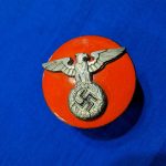 german-world-war-two-s-a-kepi-insignia-of-unknown-use-with-early-eagle-and-red-enamel-disk-in-maybe-gau-color-cap-hat